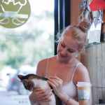 photo of woman holding a tabby cat