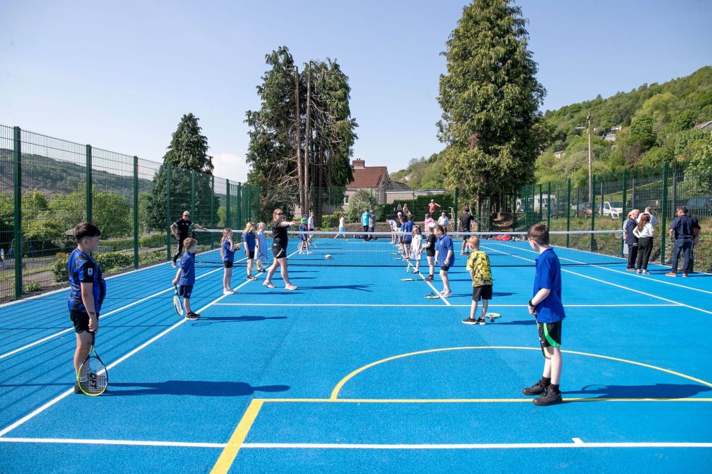 Children at the new tennis and basketball court