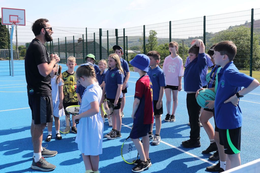 Children at the new tennis and basketball court