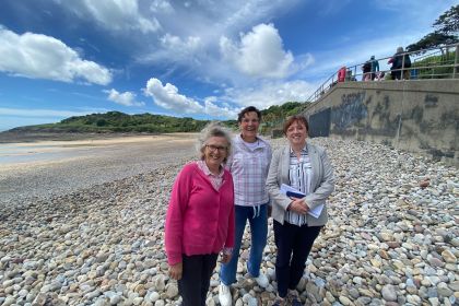 Sarah Samuel Gower Society (in pink), Tonia Antoniazzi MP and Dr Ruth Godfrey (Associate Professor in LCMS at Swansea University) pictured on Langland beach.