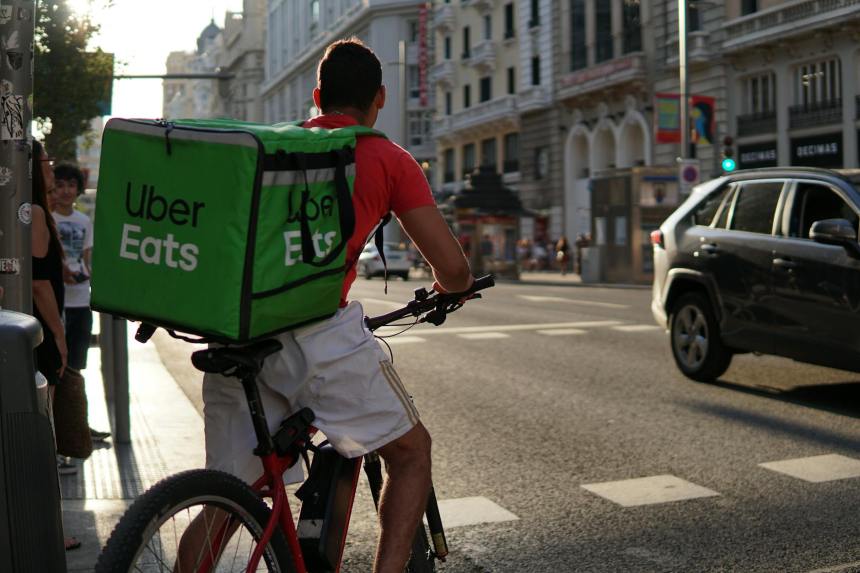 a delivery man riding a bike