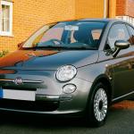 a black hatchback car parked on the road