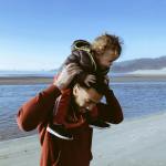 a father carrying his child on his shoulders