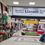 Interior view of Llanelli Market showing stalls and walkways inside the main hall.