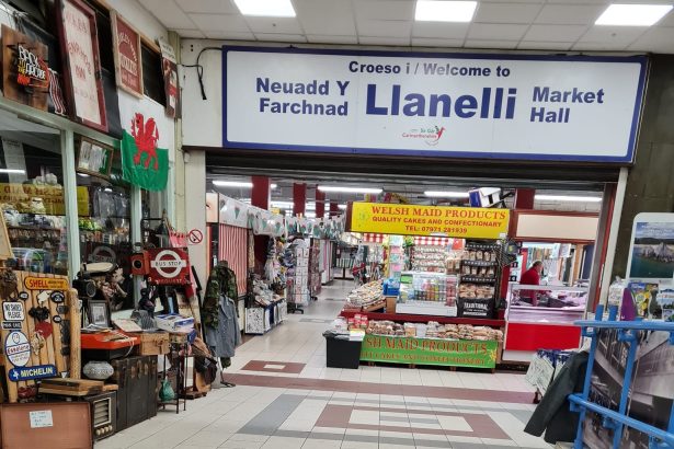 Interior view of Llanelli Market showing stalls and walkways inside the main hall.