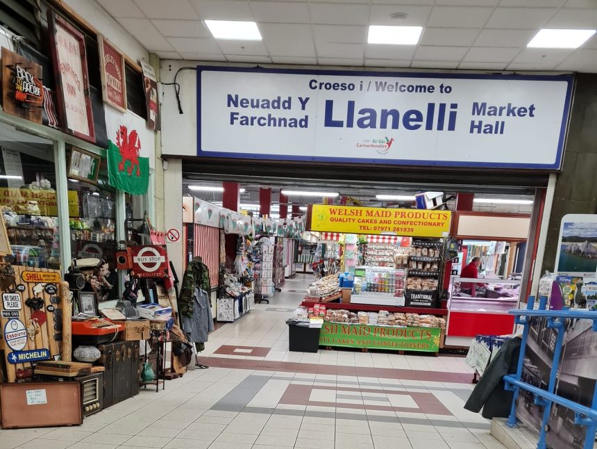 Interior view of Llanelli Market showing stalls and walkways inside the main hall.
