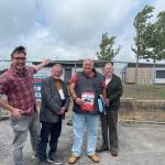Llanelli Town Council leader Cllr David Darkin points to the new Bigyn Community Centre and changing rooms at Penyfan Park, with Bigyn resident, town councillor Shaun Greaney, Bigyn community activist Neville Gilasbey, and Bigyn county and town councillor Phil Warlow (Image: Shaun Greaney)