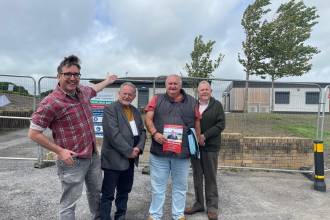 Llanelli Town Council leader Cllr David Darkin points to the new Bigyn Community Centre and changing rooms at Penyfan Park, with Bigyn resident, town councillor Shaun Greaney, Bigyn community activist Neville Gilasbey, and Bigyn county and town councillor Phil Warlow (Image: Shaun Greaney)