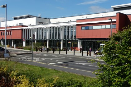 Exterior view of Morriston Hospital in Swansea, showing the main building and entrance area.