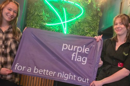 Jess, left, and Havana, of Wind Street's Peppermint Bar & Kitchen, fly Swansea's Purple Flag.