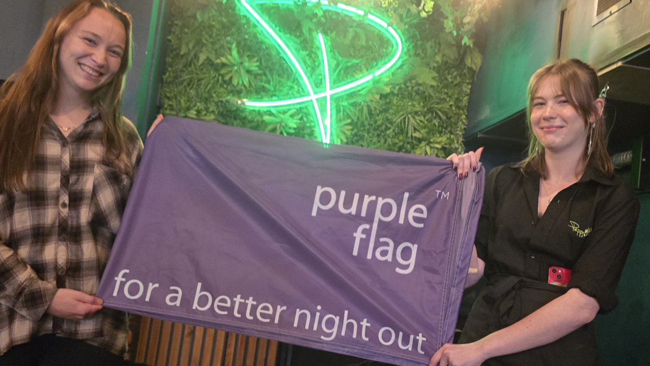 Jess, left, and Havana, of Wind Street's Peppermint Bar & Kitchen, fly Swansea's Purple Flag.