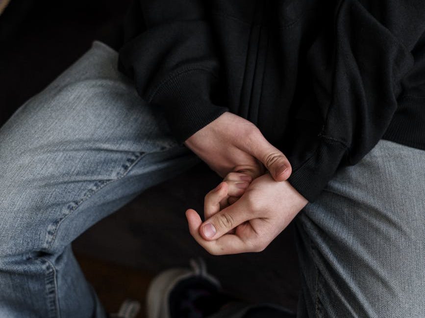 person in black jacket and gray denim jeans