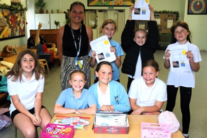 The pupils and Miss Elliw Roberts at their stall