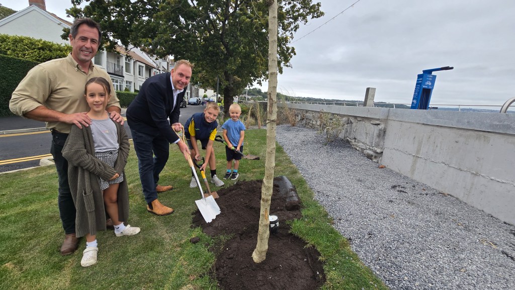 New trees being planted by local children, Council leader Rob Stewart and cabinet member Andrew Stevens