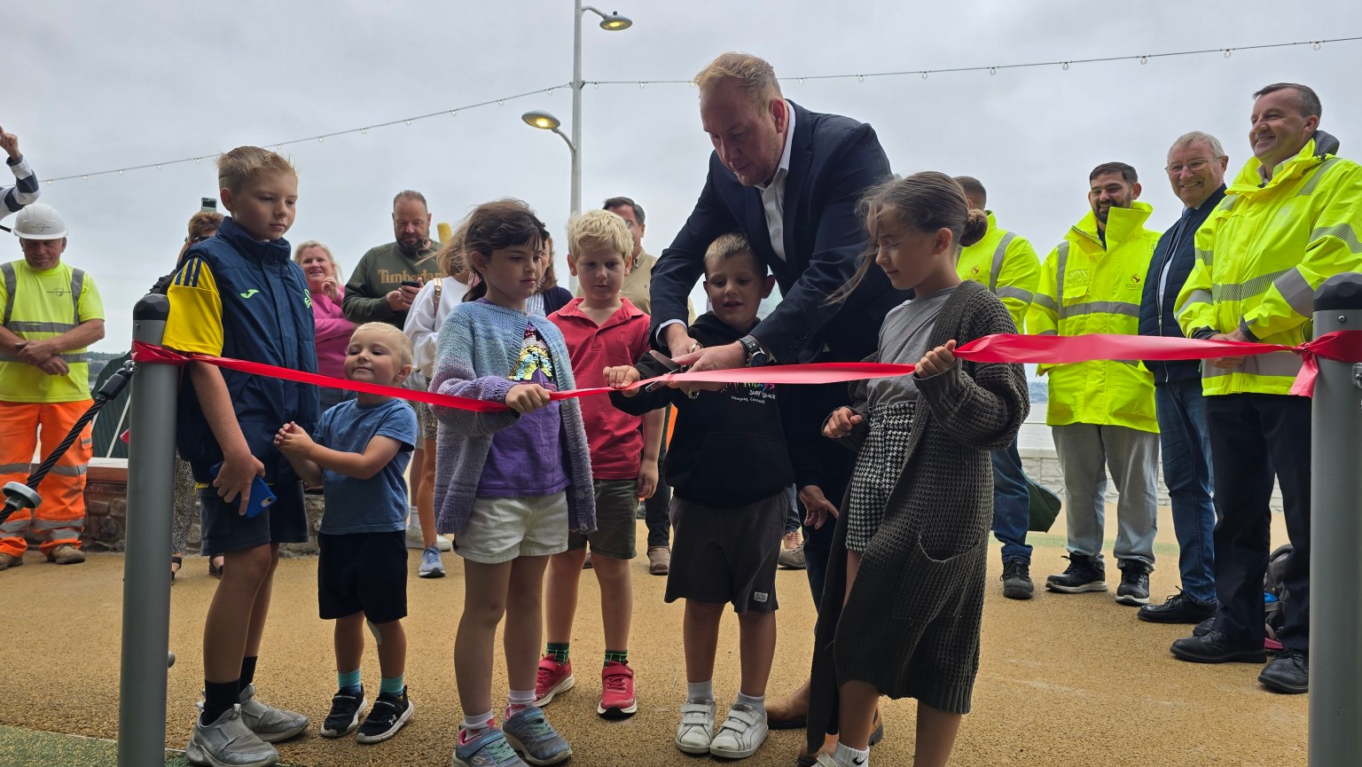The new Mumbles seafront play area being opened by local children and council leader, Rob Stewart