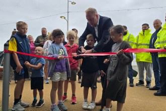 The new Mumbles seafront play area being opened by local children and council leader, Rob Stewart
