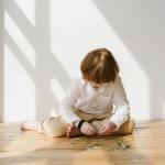 boy in white long sleeve shirt playing puzzle