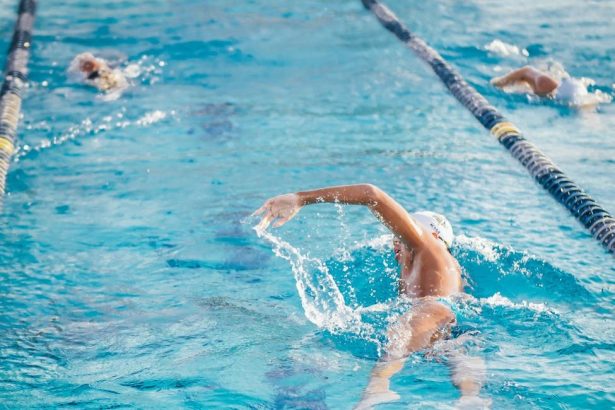man swimming on an indoor swimming pool