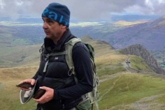 Swansea man Paul Coker, living with type 1 diabetes, standing outdoors on a mountain path. He is contributing to research aimed at improving access to eye care and preventing avoidable sight loss