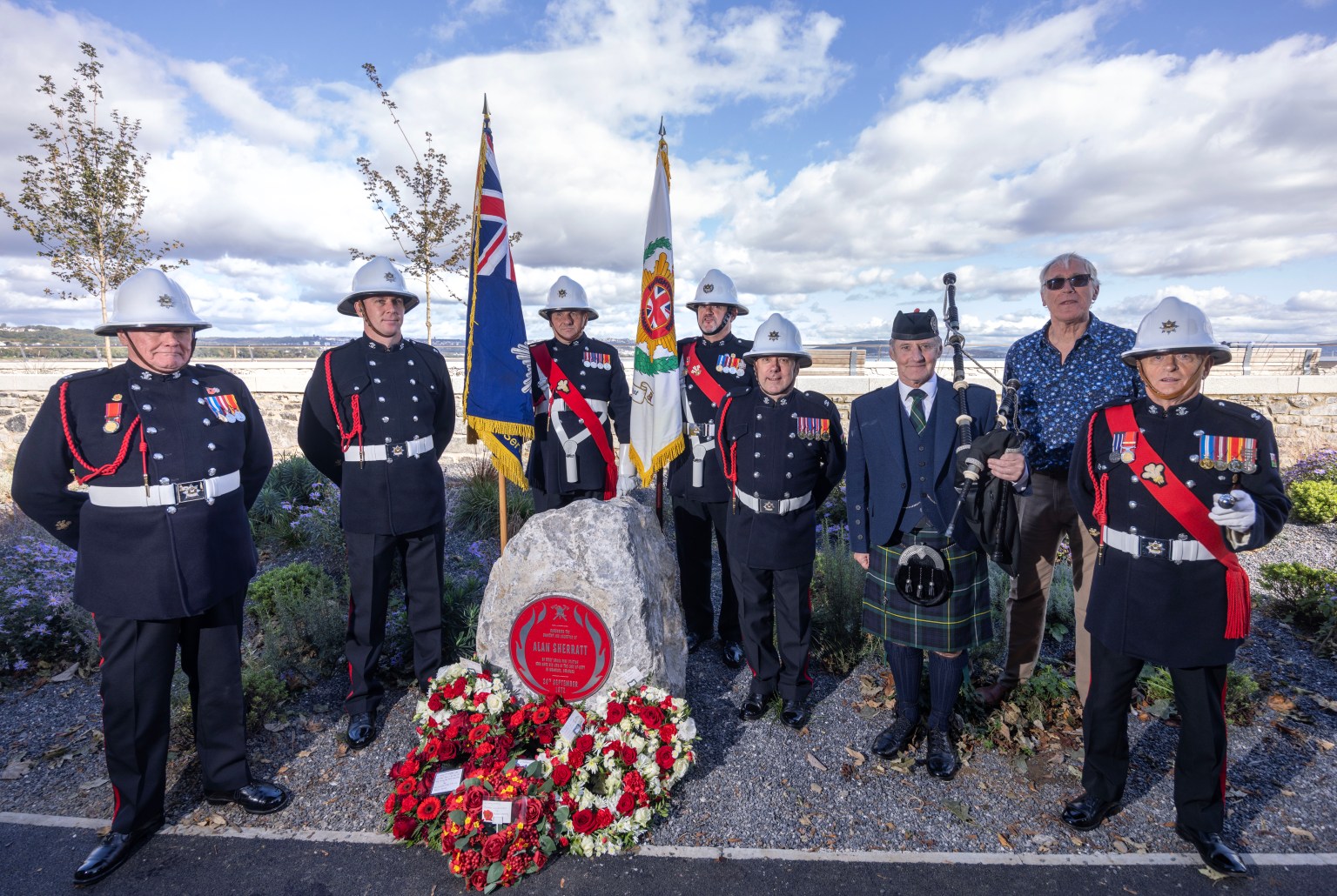Ceremonial colour parade of firefighters at Alan Sherratt’s Red Plaque unveiling in Swansea, honouring his service and sacrifice.