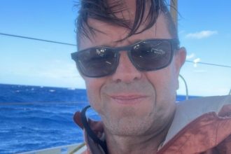 Leigh Evans seated on the deck of the flotilla yacht during preparations for the Gaza aid mission.