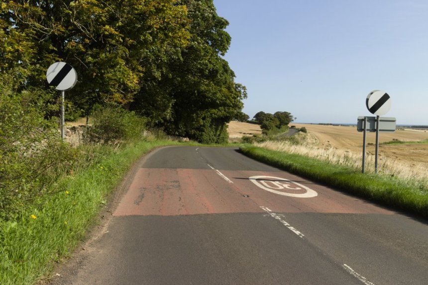 National speed limit signs on a countryside road in the UK, highlighting the current 60mph limit on rural single‑carriageways.