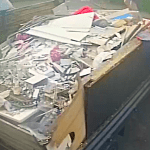 A red pickup truck filled with rubble, timber and other building materials, photographed by Neath Port Talbot Council as part of a fly‑tipping investigation