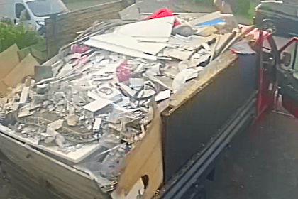 A red pickup truck filled with rubble, timber and other building materials, photographed by Neath Port Talbot Council as part of a fly‑tipping investigation
