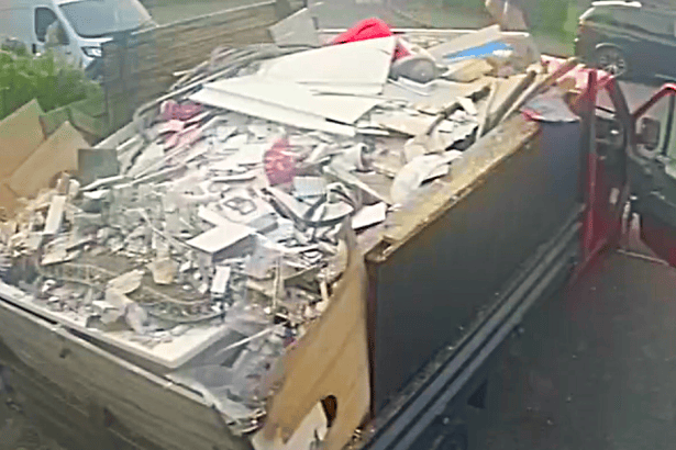 A red pickup truck filled with rubble, timber and other building materials, photographed by Neath Port Talbot Council as part of a fly‑tipping investigation