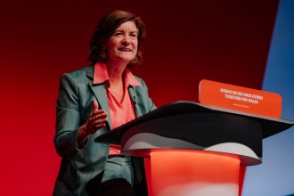 Eluned Morgan addressing the Labour Party conference from the lectern, outlining Welsh Labour’s vision for stability and delivery ahead of the Senedd election.