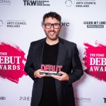 Richard Mylan holding his Best Director trophy at The Stage Debut Awards 2025, recognised for directing Mumfighter at Swansea Grand Theatre.