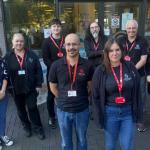 Group photo of eight Swansea Central Library staff preparing for the relocation from the Civic Centre to Y Storfa, the new community hub on Oxford Street.