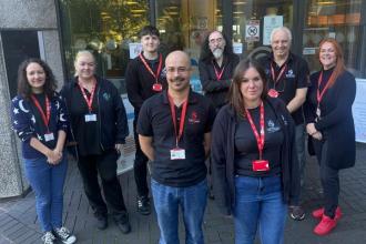 Group photo of eight Swansea Central Library staff preparing for the relocation from the Civic Centre to Y Storfa, the new community hub on Oxford Street.
