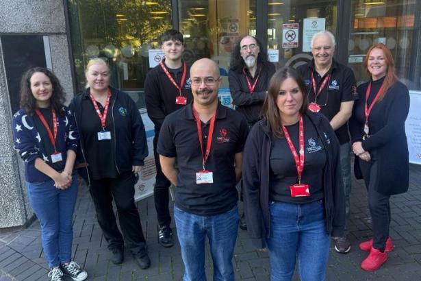 Group photo of eight Swansea Central Library staff preparing for the relocation from the Civic Centre to Y Storfa, the new community hub on Oxford Street.