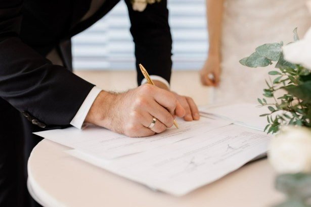 Couple signing a marriage certificate