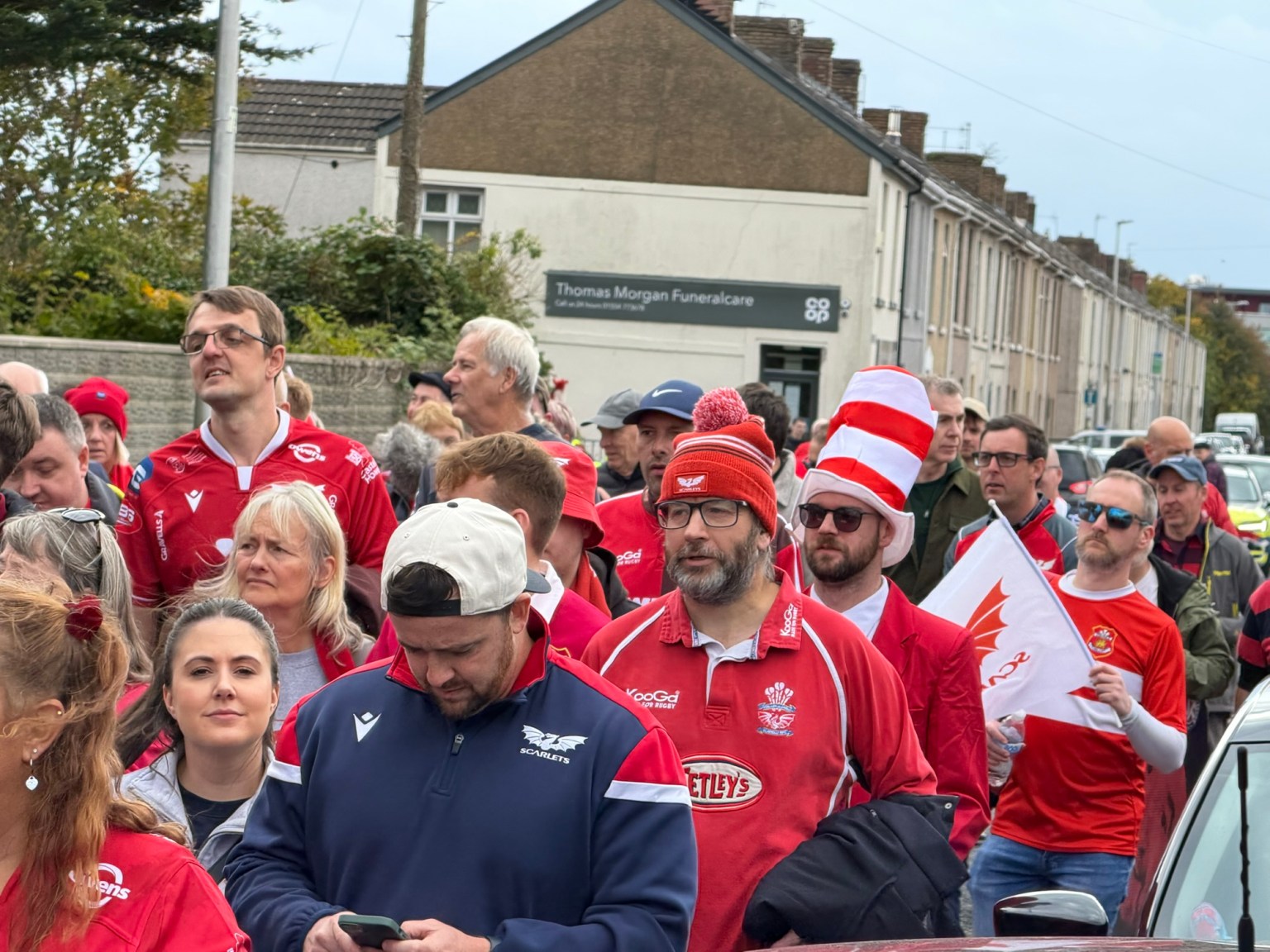 The crowds march through the narrow residential streets towards the stadium