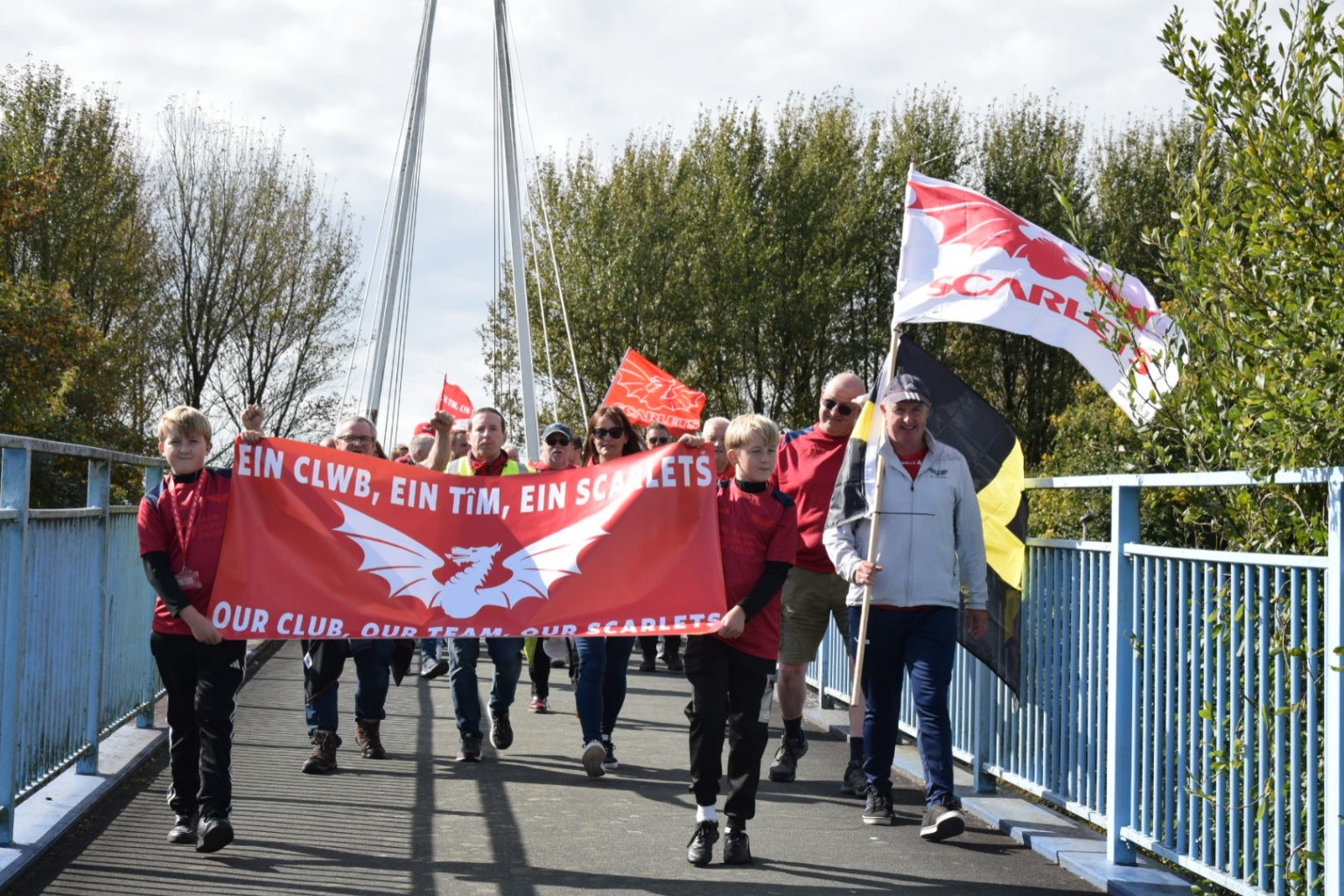 The protestors march across Pont d'Agen bridge crossing the coastal road