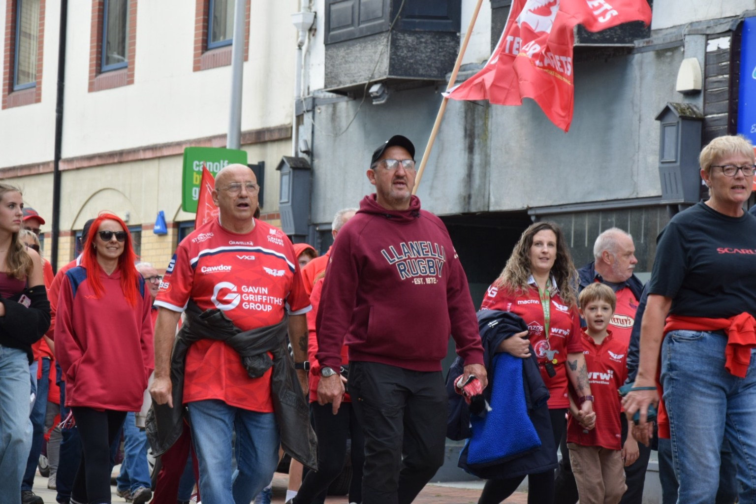 Rupert Moon joins a sea of red marching past shops and offices