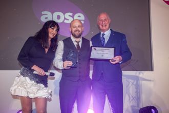 Chris Owens of Neath Port Talbot Council holding the APSE 2025 Award at the ceremony in Glasgow, recognising the council’s AI innovation in adult social care.