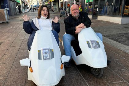 Actors Ruth Jones and Steve Speirs riding Sinclair C5s during filming for BBC Cymru Wales’ From Porthcawl with Love, a nostalgic look at Jones’ hometown of Porthcawl.