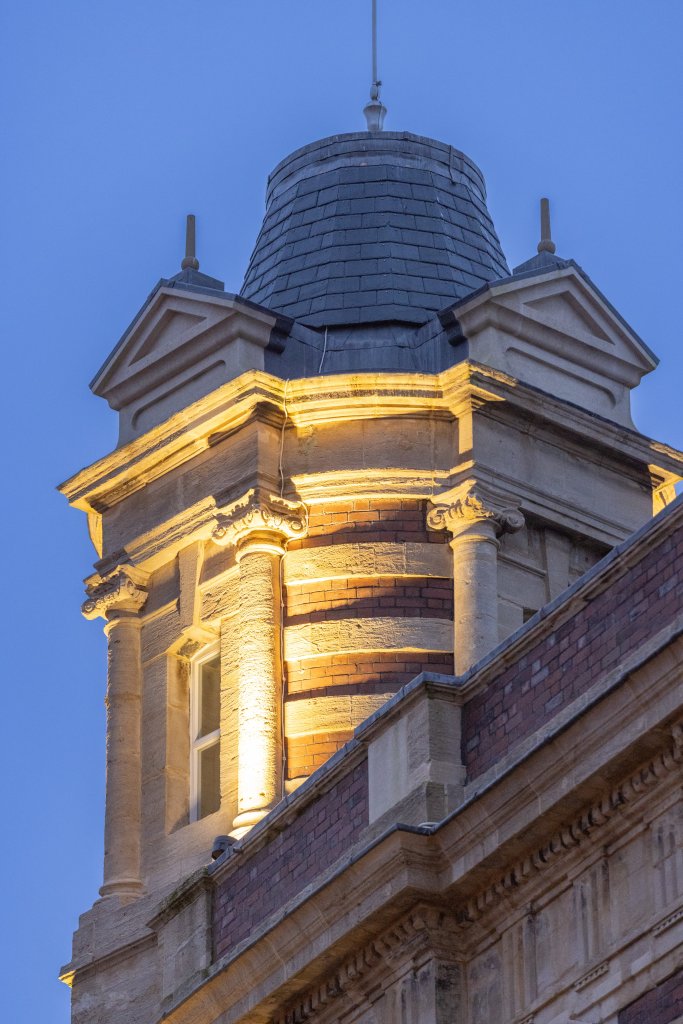 Night view of the Palace Theatre’s conical roof in Swansea, lit up after the building’s renovation.