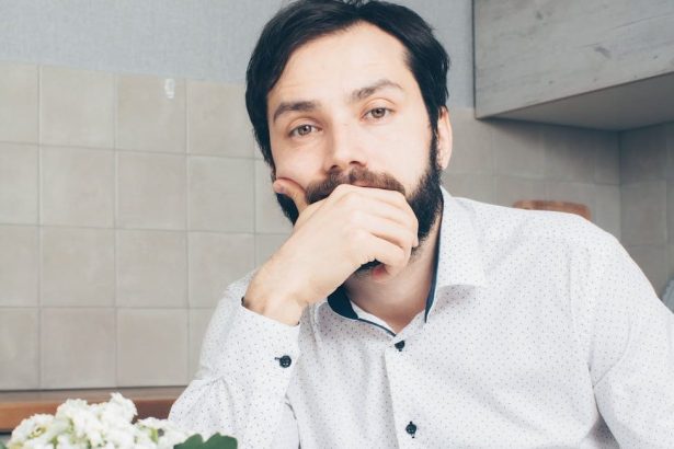 man in white dress shirt sitting at the table
