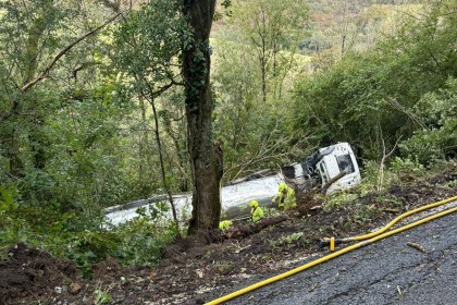 Fire crews and police at the scene of a milk tanker crash near Carmarthen after the vehicle slid down an embankment.