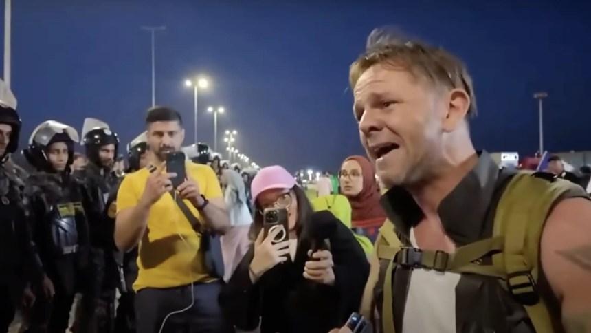 Leigh Evans crying and appealing to Egyptian police officers at the Rafah crossing into Gaza.