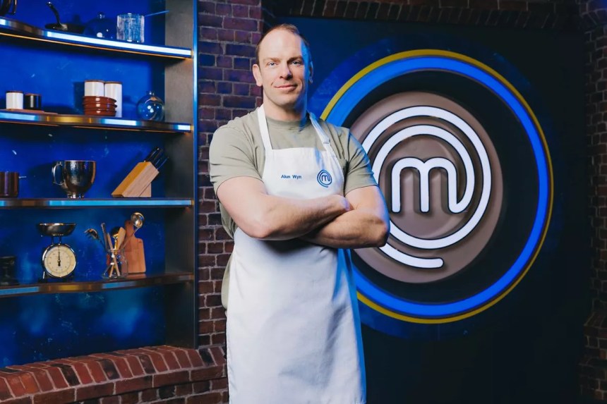 Alun Wyn Jones wearing a white Celebrity MasterChef apron in a promotional photo for the BBC cooking competition.