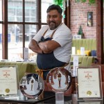 Raj Chowdhury wearing chef whites in the dining room of Raj Kitchen, Swansea.