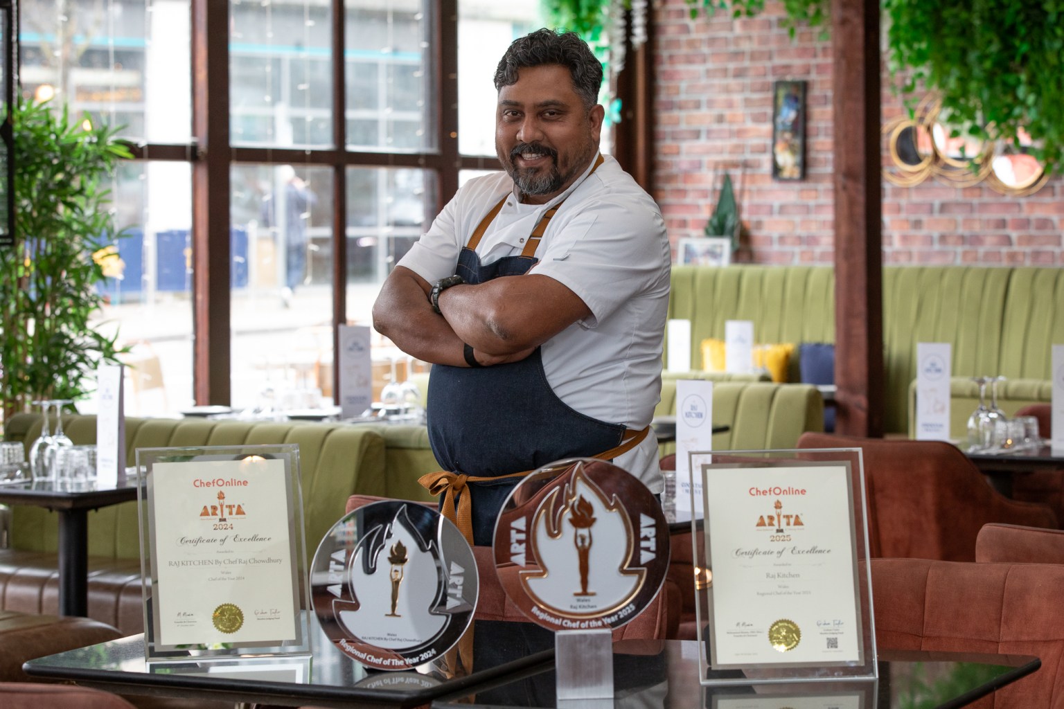 Raj Chowdhury wearing chef whites in the dining room of Raj Kitchen, Swansea.