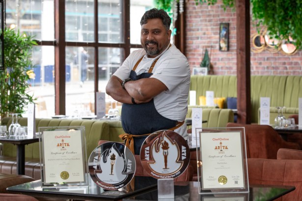 Raj Chowdhury wearing chef whites in the dining room of Raj Kitchen, Swansea.