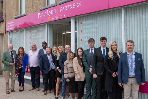 Peter Lynn and Partners staff standing outside the new Gorseinon office on Pontardulais Road.