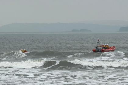 Two Burry Port RNLI lifeboats pictured in choppy waters during their 80th call‑out of 2025, launched after reports of a kite surfer in difficulty off Pembrey.